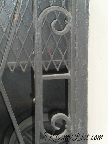 Look for the "E" in this photo of an iron door frame.